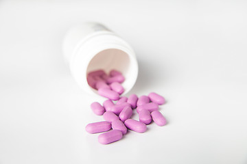 Image showing Close-up of pink scattered pill from bottle