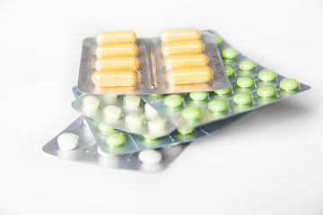 Image showing Close-up of green and white pills in blisters