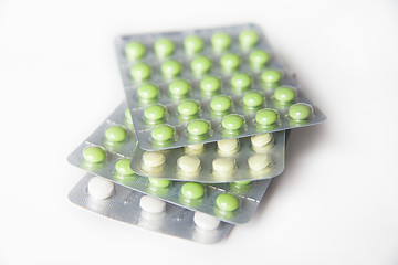 Image showing Close-up of green and white pills in blisters