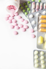 Image showing Close-up of scattered pink and colorful tablets in blisters