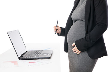 Image showing Unrecognizable businesswoman waiting baby while working on laptop