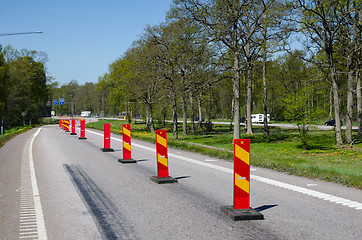 Image showing Row of colorful roadblocks