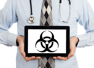 Image showing Doctor holding tablet - Warning! Biohazard!