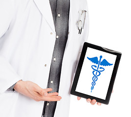 Image showing Doctor holding tablet - Caduceus symbol