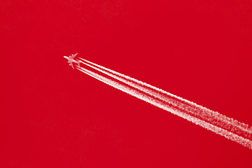 Image showing Plane in blue sky - Bright red sky