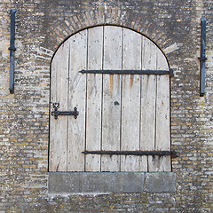 Image showing Old wooden door in a wall