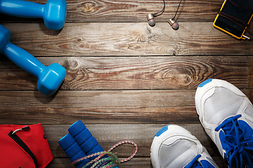 Image showing Sport stuff on wooden table, top view