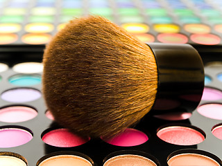 Image showing Multicolored Eye Shadows and Cosmetic Brush