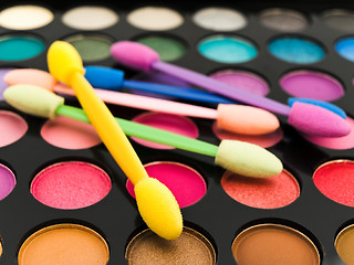 Image showing Multicolored Eye Shadows and Cosmetic Brush