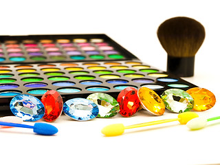 Image showing Multicolored Eye Shadows and Cosmetic Brush