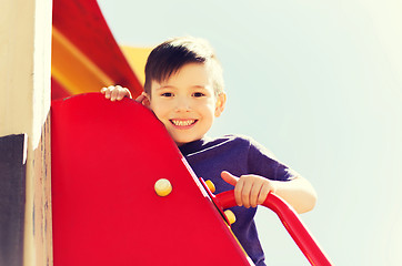 Image showing happy little boy climbing on children playground