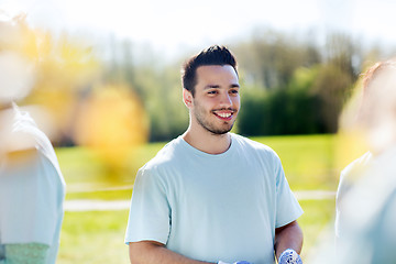Image showing happy volunteer man in park
