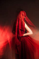 Image showing Unrecognizable woman covered with red cloth