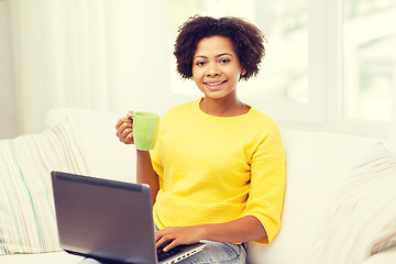 Image showing happy african american woman with laptop at home