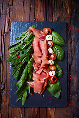 Image showing plate of salad with cherry tomatoes, arugula,