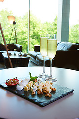 Image showing two glasses of champagne with a tray cheese