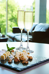 Image showing two glasses of champagne with a tray cheese