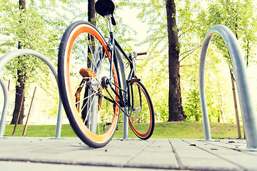 Image showing close up of bicycle locked at street parking