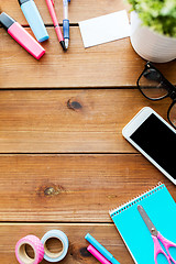 Image showing close up of stationery and smartphone on table