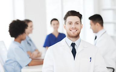 Image showing happy doctor over group of medics at hospital