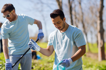 Image showing volunteers with garbage bags cleaning park area