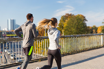 Image showing happy couple running outdoors