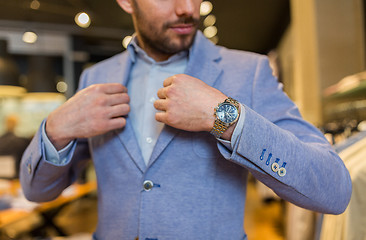 Image showing close up of man trying jacket at clothing store