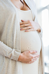 Image showing close up of pregnant woman belly and hands