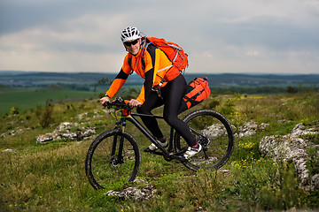 Image showing Young man is riding bicycle outside. Healthy Lifestyle.