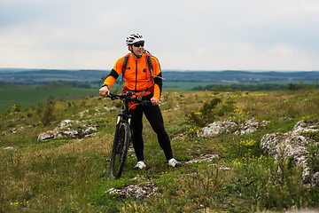 Image showing Young man is riding bicycle outside. Healthy Lifestyle.