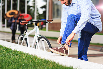 Image showing young hipster man with fixed gear bike on city street