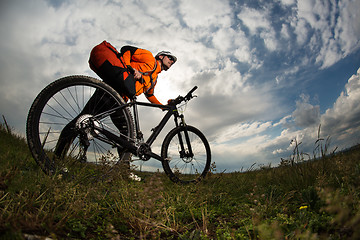 Image showing Young man is riding bicycle outside. Healthy Lifestyle.