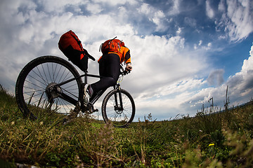 Image showing Young man is riding bicycle outside. Healthy Lifestyle.