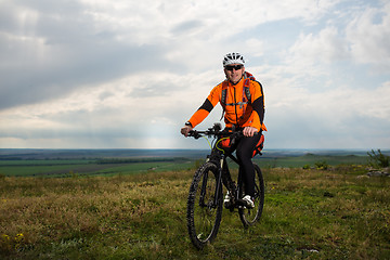 Image showing Young man is riding bicycle outside. Healthy Lifestyle.