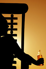 Image showing Beer and Deckchair sunset silhouette