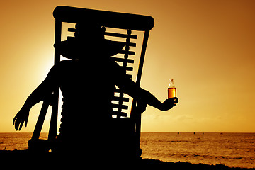 Image showing Beer and Deckchair sunset silhouette