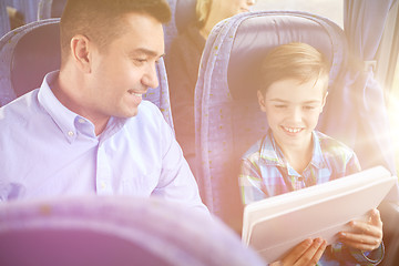 Image showing happy family with tablet pc sitting in travel bus