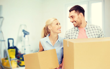 Image showing couple with cardboard boxes moving to new home