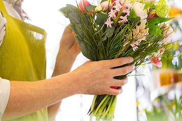 Image showing close up of man making bunch at flower shop