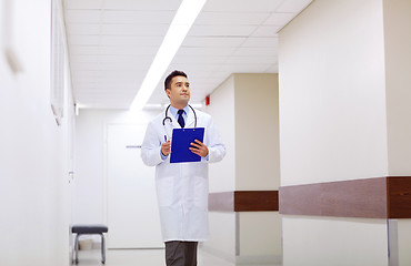 Image showing doctor with clipboard walking along hospital