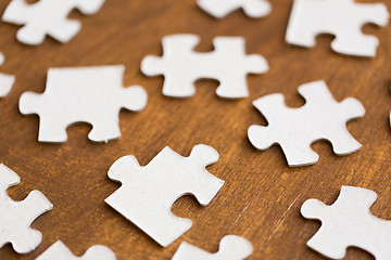 Image showing close up of puzzle pieces on wooden surface