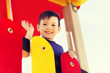 Image showing happy little boy climbing on children playground