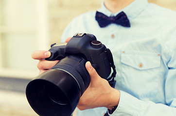 Image showing close up of male photographer with digital camera