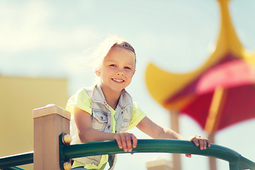 Image showing happy little girl climbing on children playground