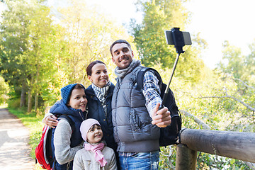 Image showing family with backpacks taking selfie and hiking