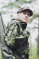 Image showing young soldier or hunter with gun in forest