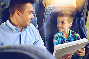 Image showing happy family with tablet pc sitting in travel bus