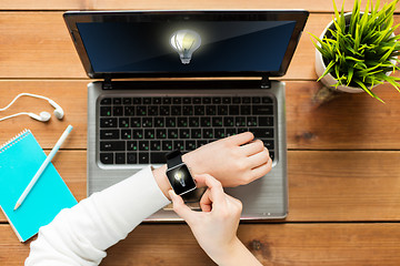 Image showing close up of woman with smart watch and laptop