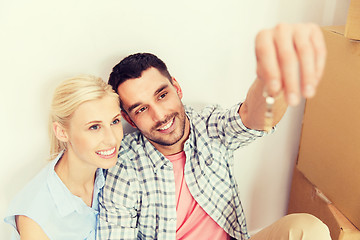 Image showing couple with key and boxes moving to new home