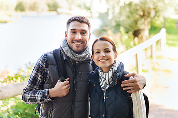 Image showing happy couple with backpacks hiking and hugging